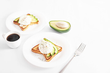 Toast with poached eggs and avocado. Healthy breakfast and food. Cozy morning. Nutrition for pregnant. Diet for women. Breakfast in hotel room or bed. Scrambled eggs sandwich.