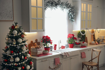 Beautiful kitchen interior with Christmas tree and festive decor