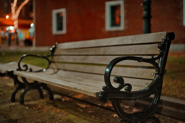 Dark Park Bench At Night In Front Of A Brick Building In Dover NH (New Hampshire)