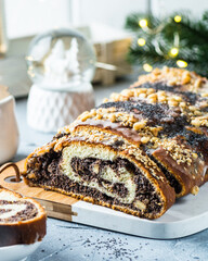 Christmas poppy seed cake, sliced poppy seed cake covered with icing and decorated with raisins and...