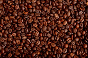 Fototapeta premium Freshly roasted coffee beans background, close-up