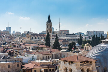 Fototapeta na wymiar Aerial view of the old city with blue sky of Jerusalem. Christian quarter and dome of the Church of the Holy Sepulchre and Monastery of Saint Saviour. View from the Lutheran Church of the Redeemer.