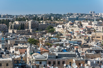 Fototapeta na wymiar Aerial view of rooftops of buildings in the old city with blue sky of Jerusalem. View from the Lutheran Church of the Redeemer.