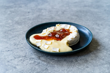 Baked Brie Cheese Dessert with Strawberry Jam. Marmalade Melted Camembert.