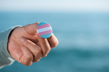 person showing a transgender pride flag