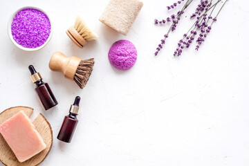 Obraz na płótnie Canvas Flat lay of lavender cosmetics - bath salt and essential oil, top view