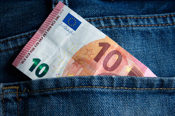 10 euro money banknote in a blue jeans pocket. selective focus