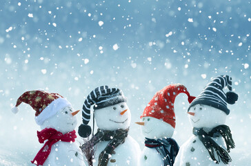 Merry Christmas and happy New Year greeting card with copy-space.Many snowmen standing in winter...