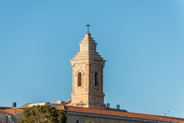 Fototapeta premium Bell tower of Pater Noster Church under sunset on the top of Mount of Olives, Jerusalem