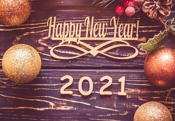 Happy new year 2021 on wooden brown background
