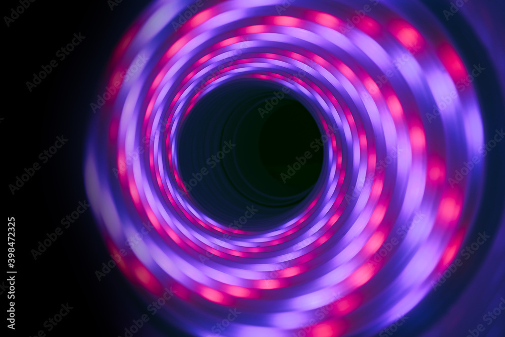 Poster beautiful abstract swirl tunnel with pink and blue neon light on a background pttern textured for de