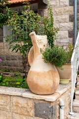 Decorative  flower pot and flowers planted near the house in the Muslim Circassian - Adyghe village...