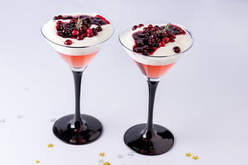 Healthy Christmas Dessert with Jelly Yogurt and Berries in Glasses on Blue Background Holiday Dessert Horizontal
