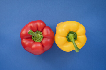 A red and yellow pepper on a blue background. Complimentary color style. 