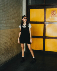 Woman smiling outdoors wearing black dress, fashion concept