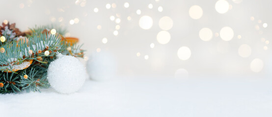 Fototapeta na wymiar Christmas light background of fir branches and white and blue balloons. bokeh garlands, place for text, banner