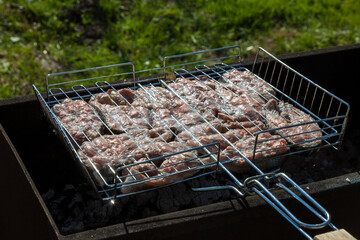 Top view of the browned steaks of red coho salmon fried on charcoal in a barbecue on a summer day in the country. Cooking a wholesome outdoor grill dinner.