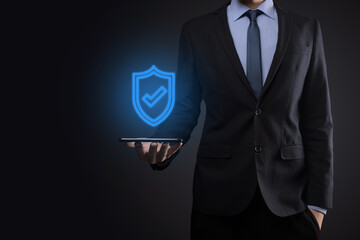 Protection network security computer in the hands of a businessman. business, technology, cyber security and internet concept - businessman pressing shield button on virtual screens Data protection
