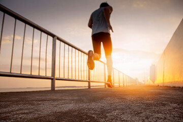 Blurred vision of joggers on the runway leading to the light