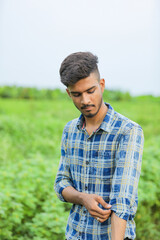 Young indian man showing expression over nature background