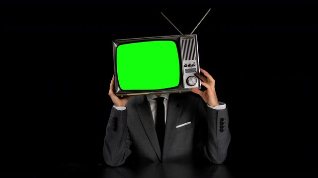Man wearing suit with TV on head