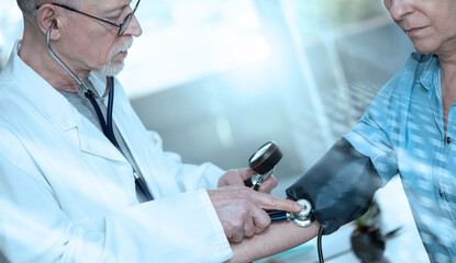 Blood pressure measurement of a female patient; light effect