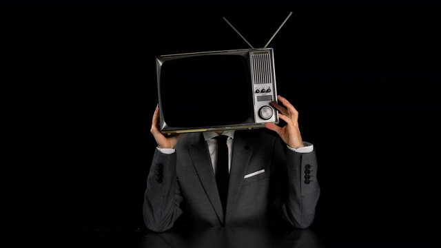 Man wearing suit with TV on head