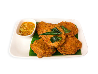 Fried fish cakes with sweet sauce peanut deep sprinkled with fried kaffir lime leaves on white plate. Asia food, Top view, Clipping path.