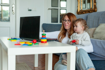Mom and baby working from home. Lockdown concept.