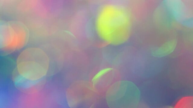 Christmas colorful city light background. Defocused, violet and pink holographic bokeh. Holiday garland decor. Abstract blurred bokeh effect. New year holo flare wallpaper