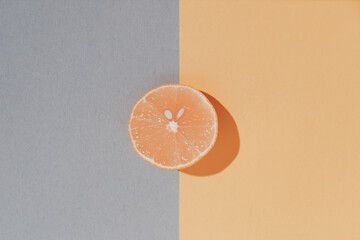 Creative layout made of fresh orange on colorful background.