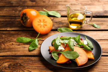 Delicious persimmon salad served on wooden table