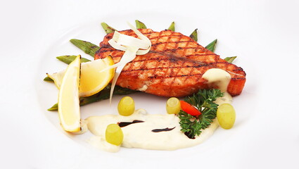 Grilled fish with sauce and lemon