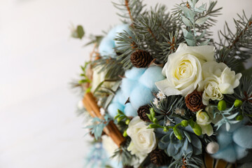 Obraz na płótnie Canvas Beautiful wedding winter bouquet on light background, closeup. Space for text