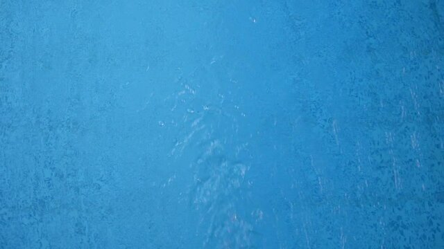 The water swirling on the surface of a swimming pool