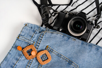 Feminine summer fashion composition with sneakers and a camera on a white background. Top view a...