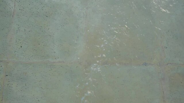 The water swirling on the surface of a swimming pool