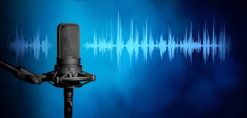 Microphone in the light with blue waveform on modern blue background, broadcasting or podcasting...