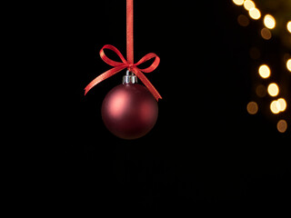 Christmas ball hanging against blurred lights