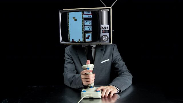 Man with TV on head playing video games