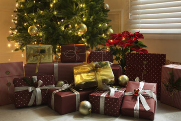Many different gifts under Christmas tree indoors