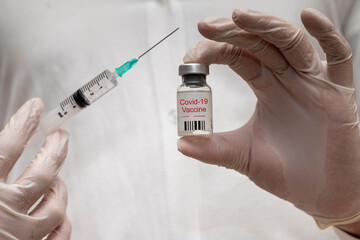 Coronavirus vaccine concept with a syringe. Covid-19, 2019-nCov pandemic.