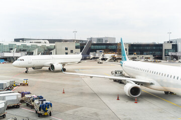 Low-cost airplanes queue for loading on airfield