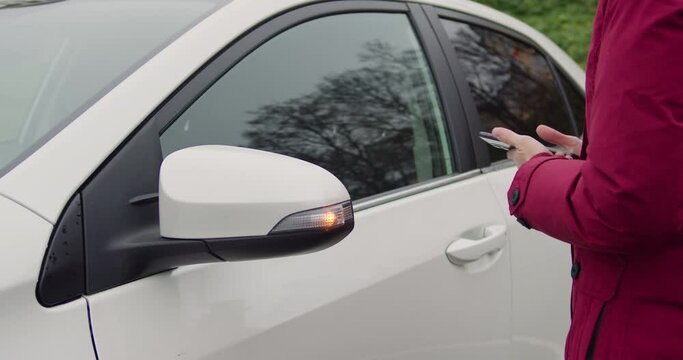 Woman Opening Car Door Using Key App In Her Phone