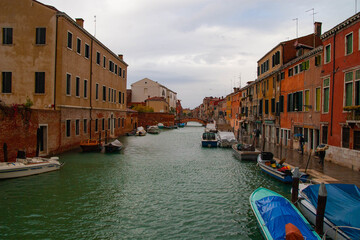 Fototapeta na wymiar Cloudy and rainy day in the channels of Venice, Venetian, Italy
