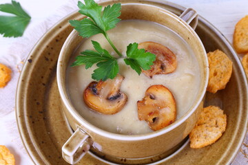 mushroom soup puree with crackers on a wooden table