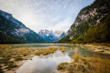 Naklejka na ściany i meble Reflection in the Lake Toblach, Lago di Dobbiaca in South Tyrol, Italy