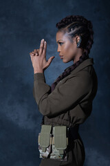 Attractive girl wearing military style clothes posing in studio