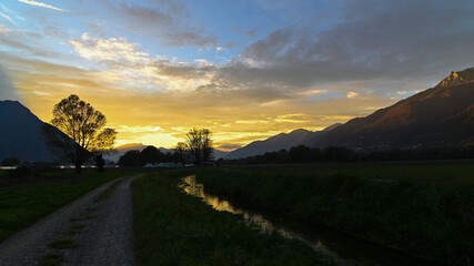 Suggestivo tramonto su un prato in autunno, con nuvole dorate. Immagine molto bella.  © fotonaturali