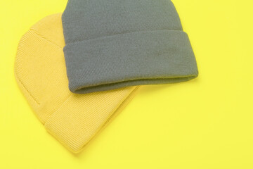 Colors of the year 2021 Ultimate Gray and Illuminating background. Gray and Illuminating .winter hats on a yellow background. Clothing in design and color trend